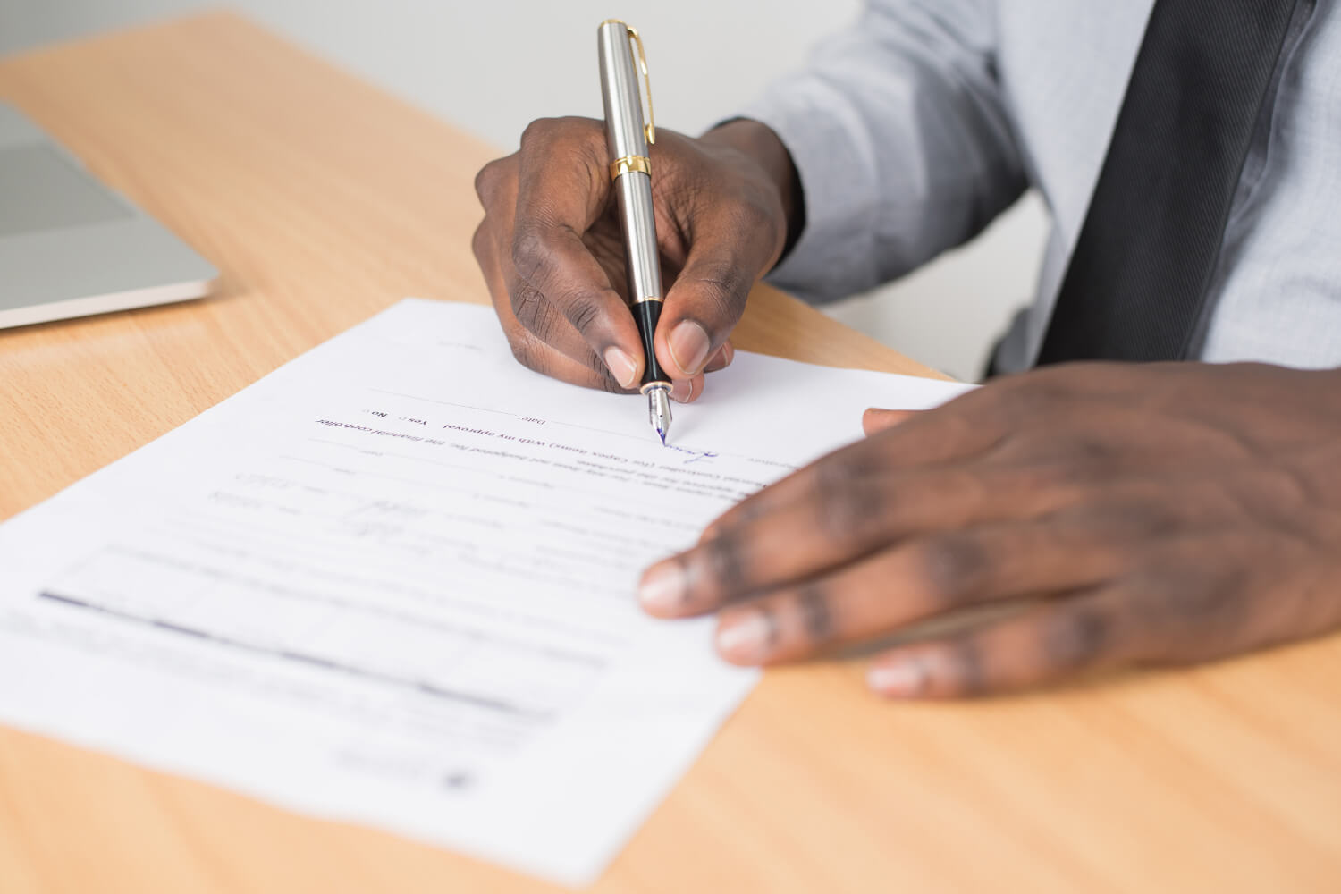 Black man signing a document