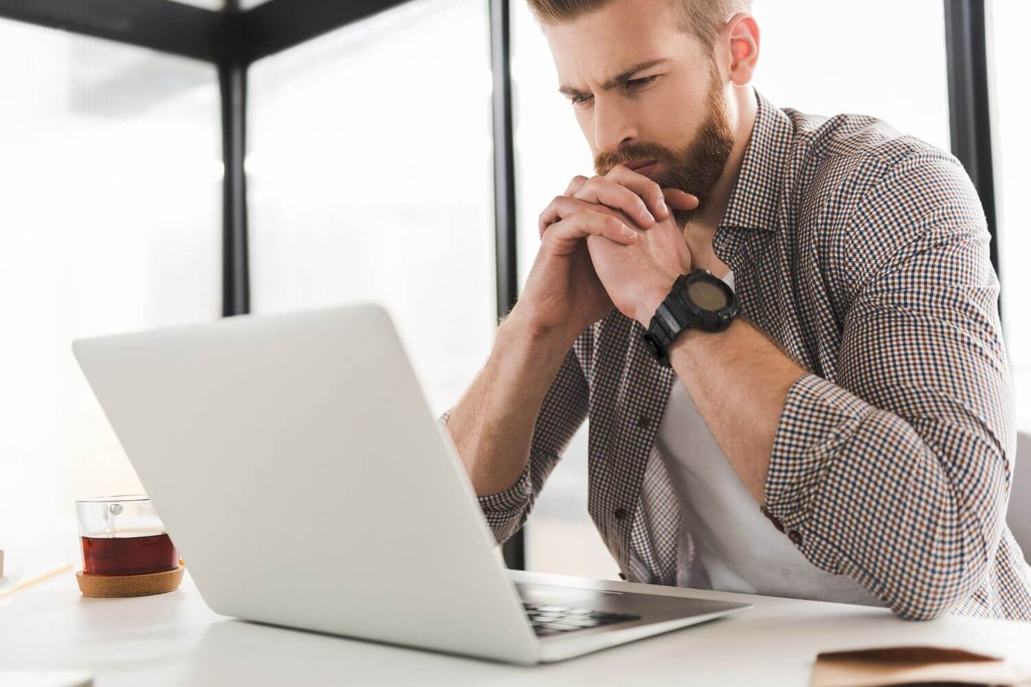 Man at a laptop looking concerned