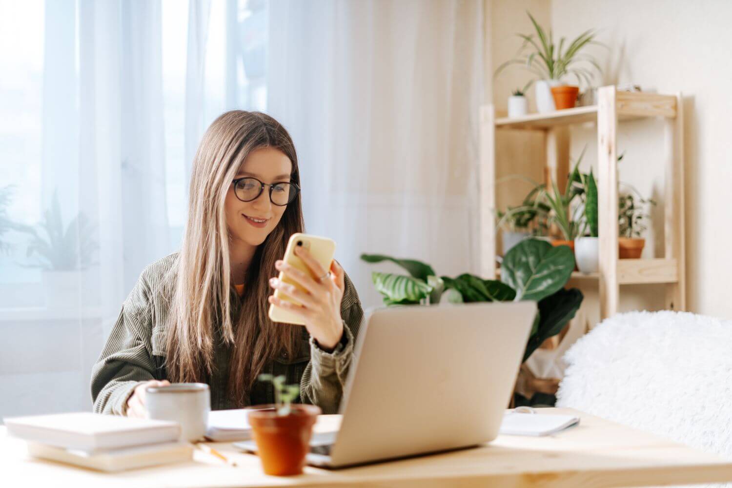 Female contractor working with laptop and mobile phone