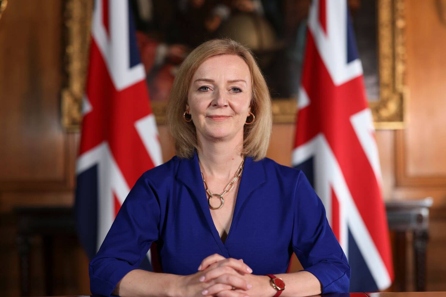 Liz Truss in front of two Union Flags