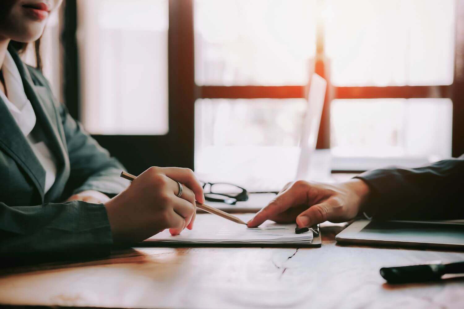 What does IR35 insurance cover - image: two people discussing business documents