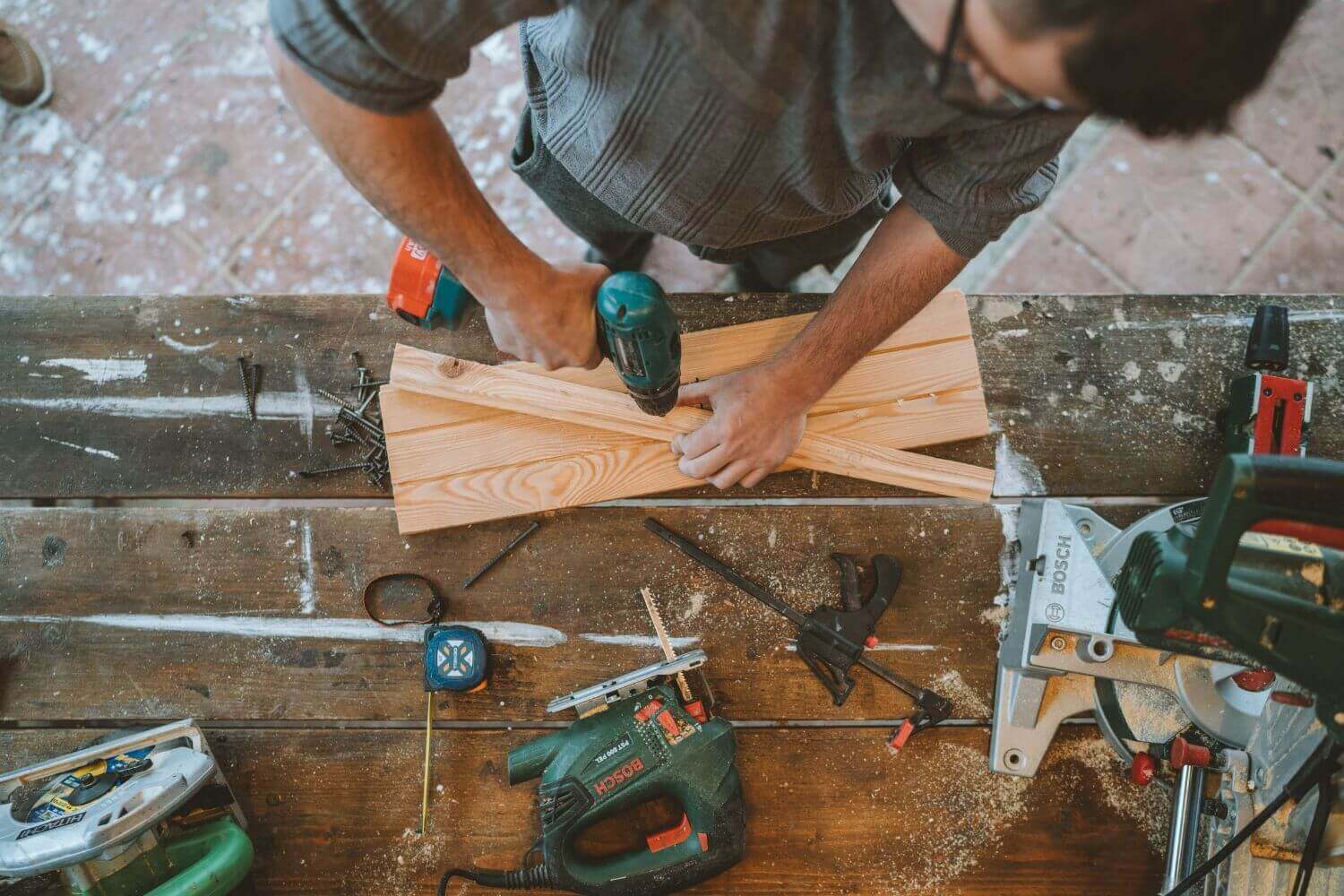 Image is Tradesman with tools. Read about tool theft insurance, including what it covers and policy considerations