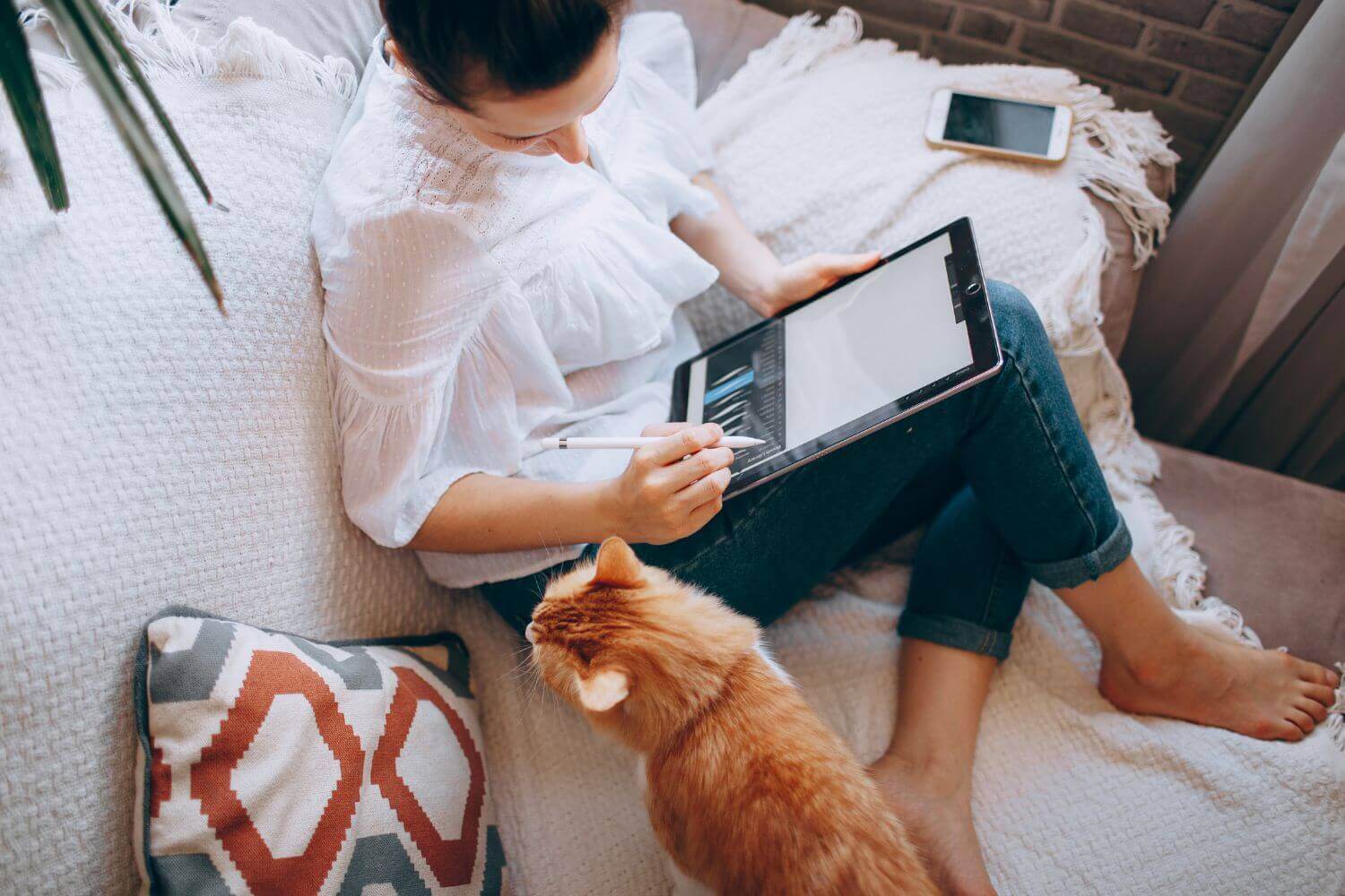 Image of a graphic designer drawing on a tablet, representing an article on what business insurance for graphic designers is and what it covers
