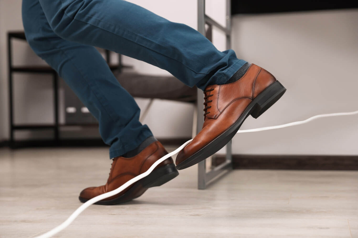 Image of person tripping over loose cable, representing article discussing the difference between public liability vs product liability