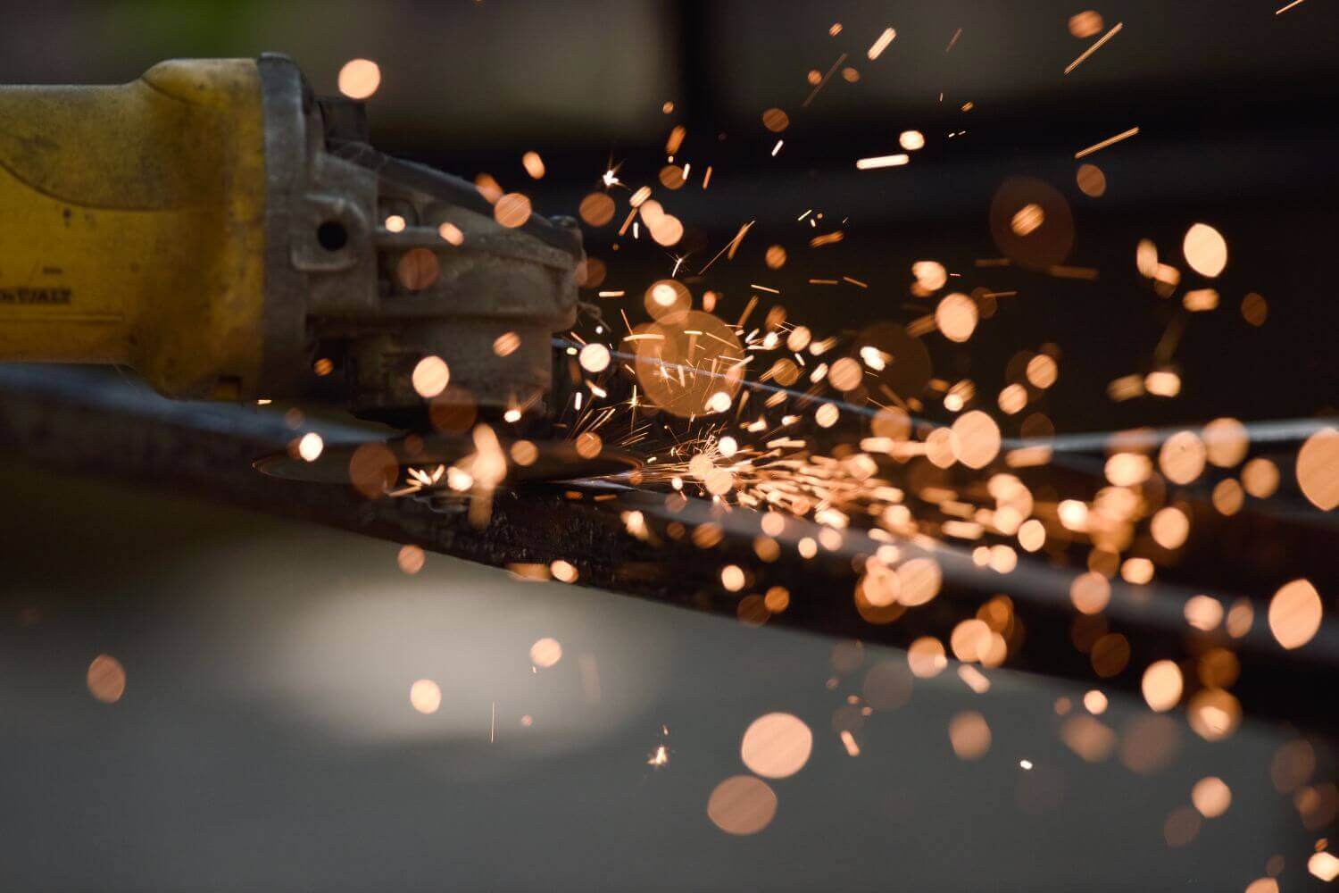 Image of sparks caused by power tools, representing article on what makes a trade high risk for insurance