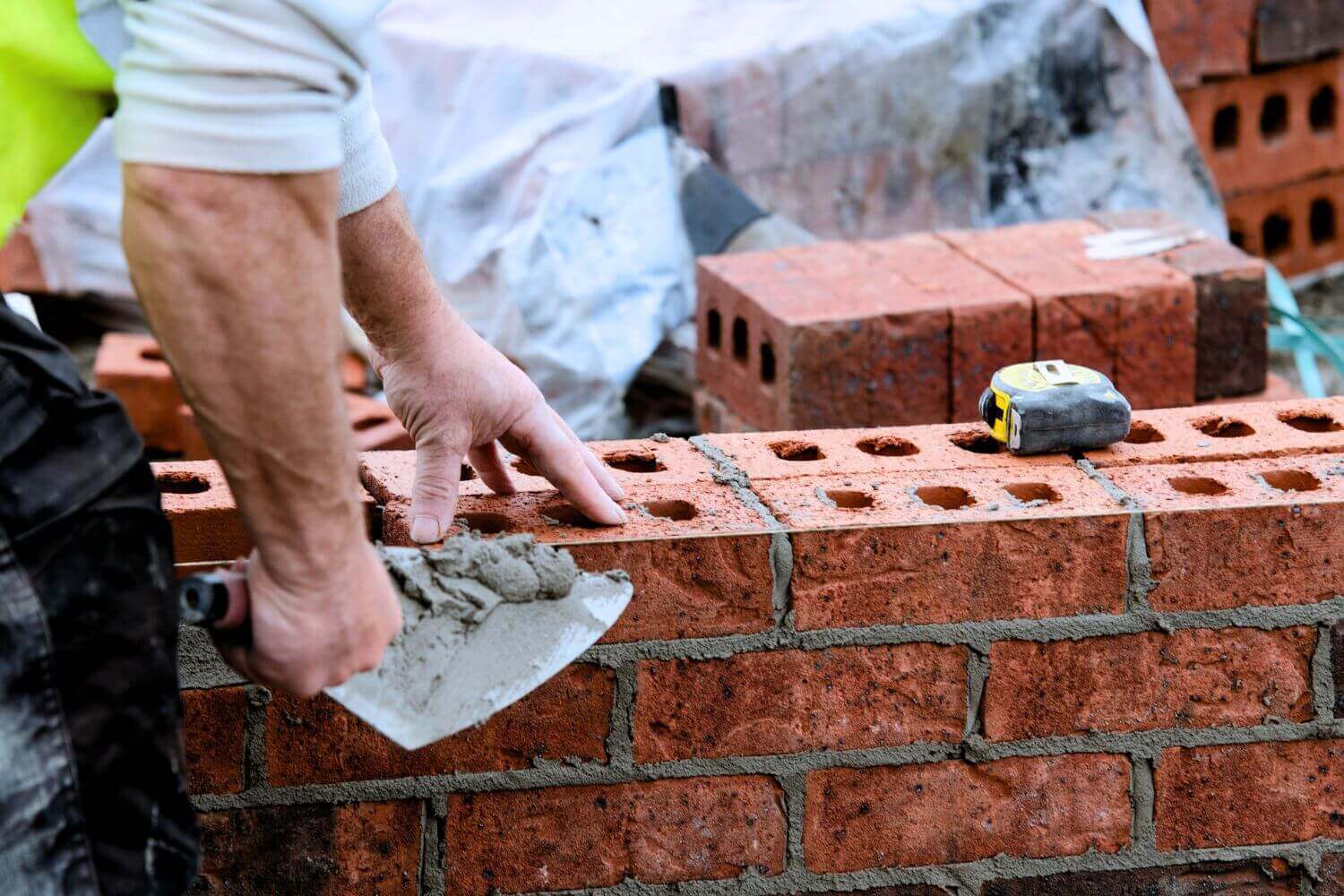 Image of bricklaying representing article on who needs trades insurance and what it covers