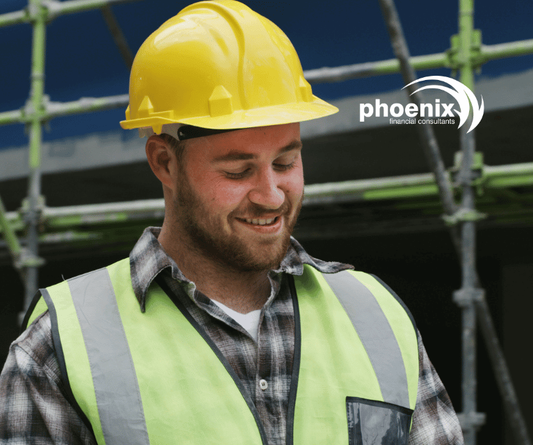 Construction worker stood in front of scaffolding wearing a hardhat and high-visibility vest